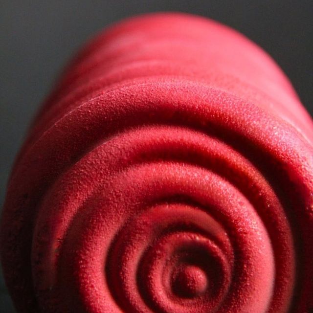 Le bout de sa bûche framboise, la spirale de glaçage miroir